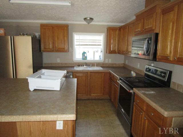 263 George Hairston Road Fieldale, VA 24089 - Photo 6 of 22 a kitchen with stainless steel appliances granite countertop a stove a sink and a refrigerator