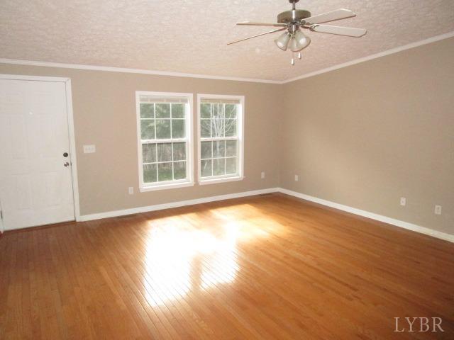 263 George Hairston Road Fieldale, VA 24089 - Photo 9 of 22 a view of empty room with wooden floor and fan