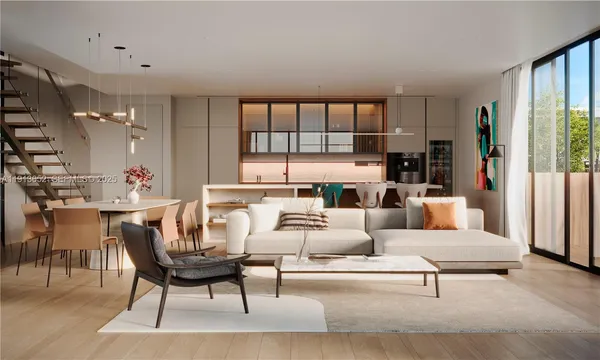 a living room with furniture kitchen view and large window