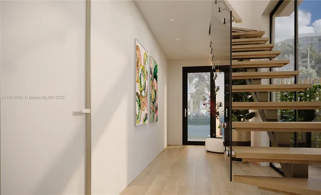 a view of a hallway with furniture and entryway
