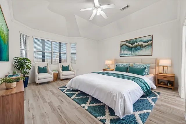 a bedroom with a bed and a chandelier