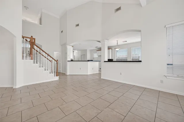 wooden floor in an empty room with a fan