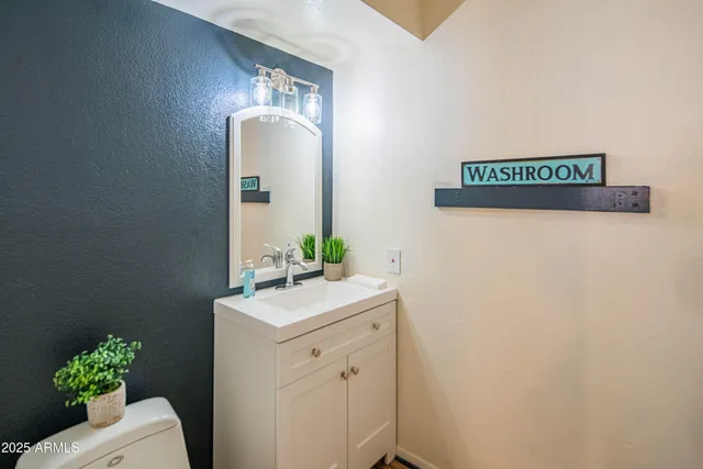 a bathroom with a sink a mirror and vanity