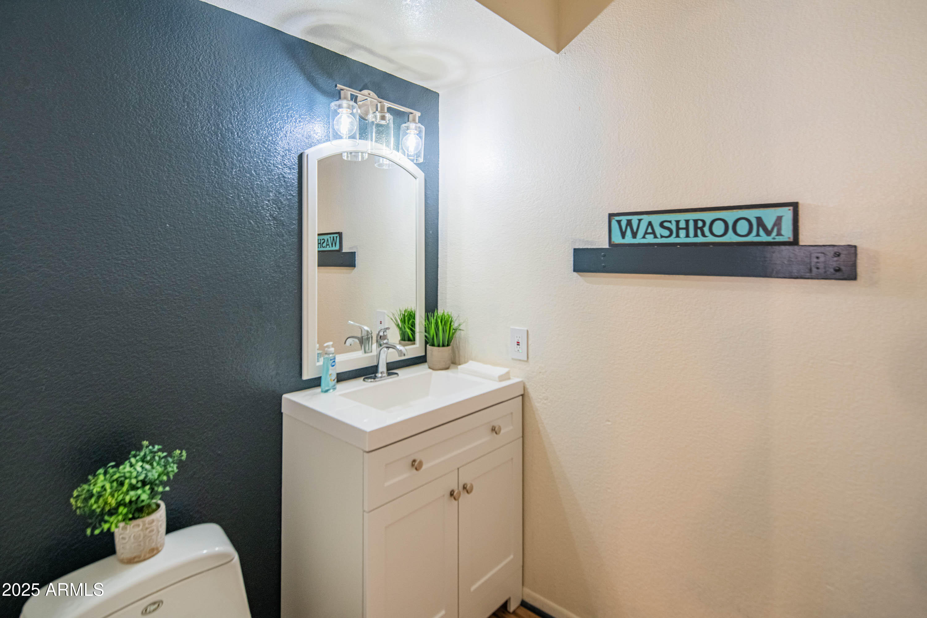 3203 West Royal Palm Road Phoenix, AZ 85051 - Photo 14 of 29 a bathroom with a sink a mirror and vanity