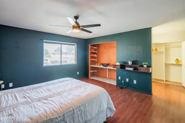 a bedroom with a bed and a dresser