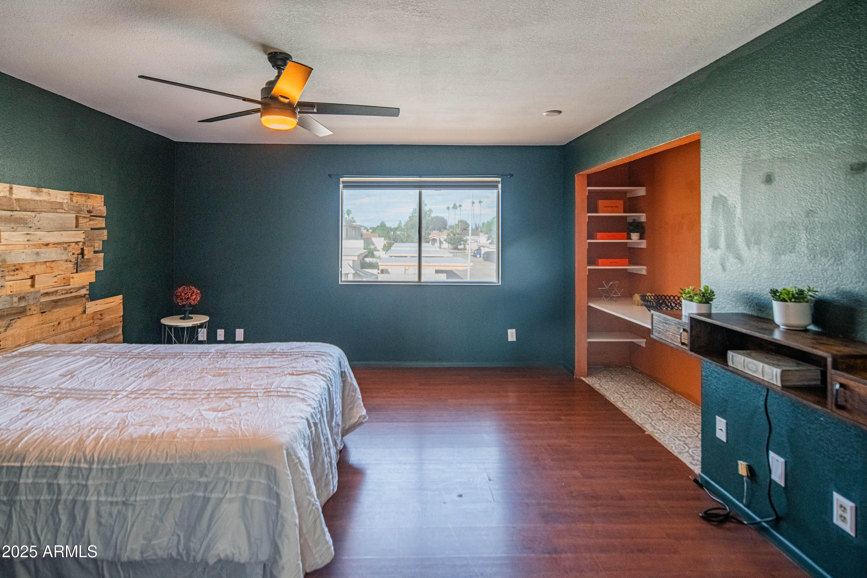 3203 West Royal Palm Road Phoenix, AZ 85051 - Photo 16 of 29 a bedroom with a bed and a chandelier fan