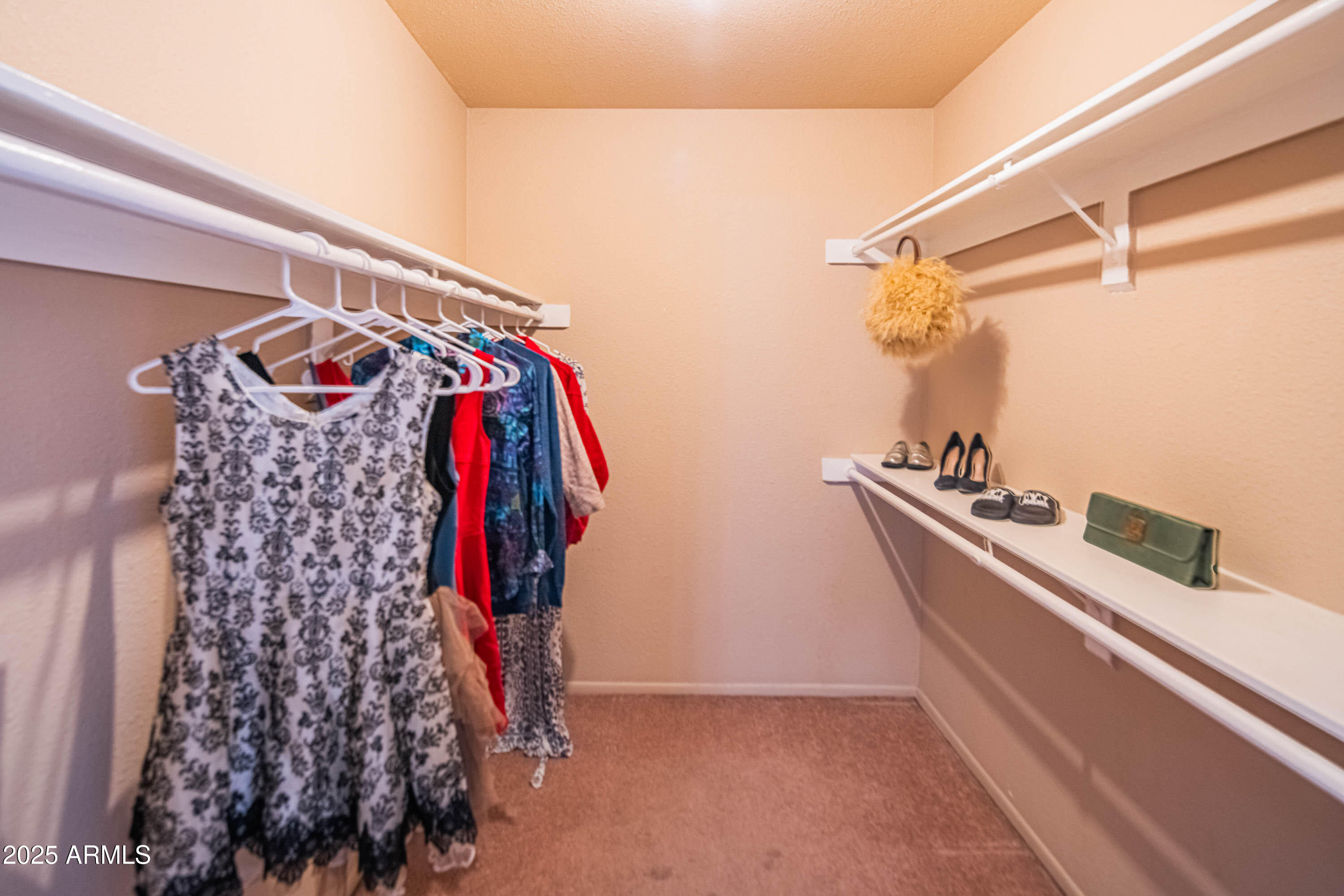 3203 West Royal Palm Road Phoenix, AZ 85051 - Photo 18 of 29 a view of walk in closet with clothes and shoes