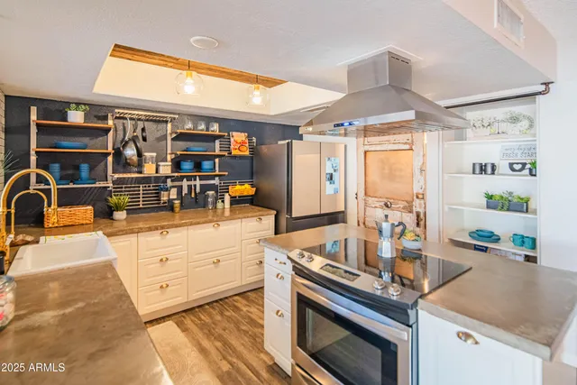 a kitchen with stainless steel appliances granite countertop a stove and a sink