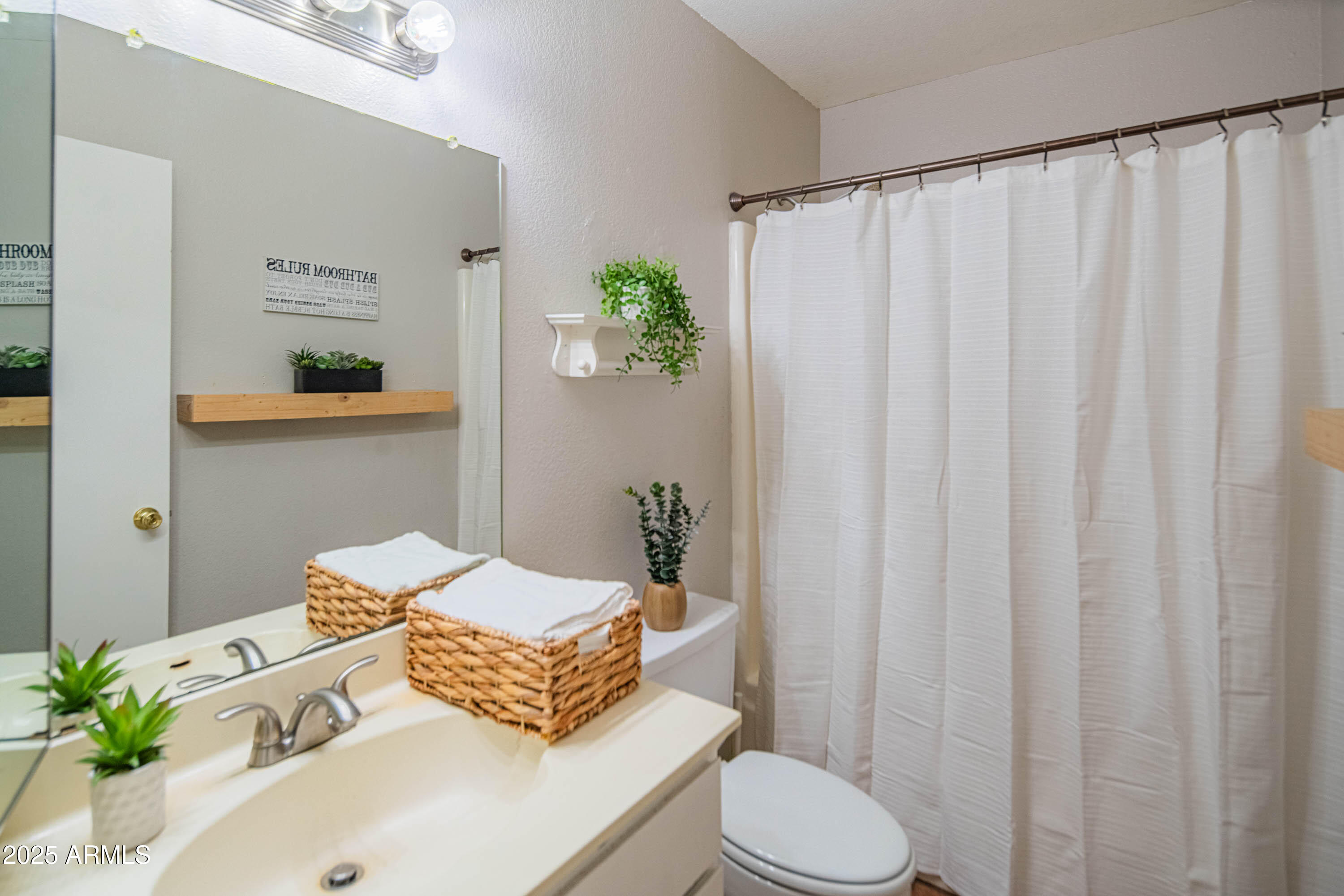 3203 West Royal Palm Road Phoenix, AZ 85051 - Photo 22 of 29 a bathroom with a sink and a mirror
