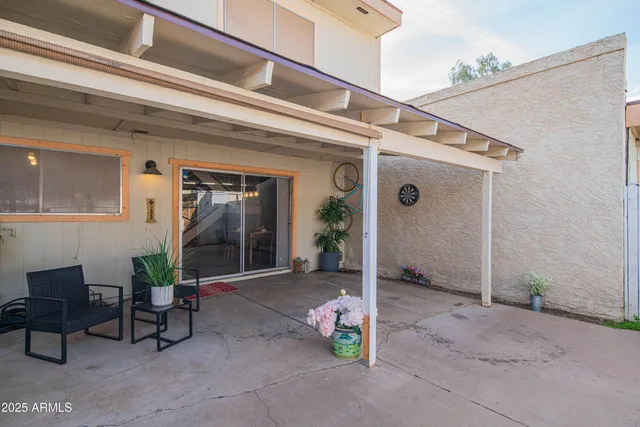 a view of a porch with furniture and a backyard