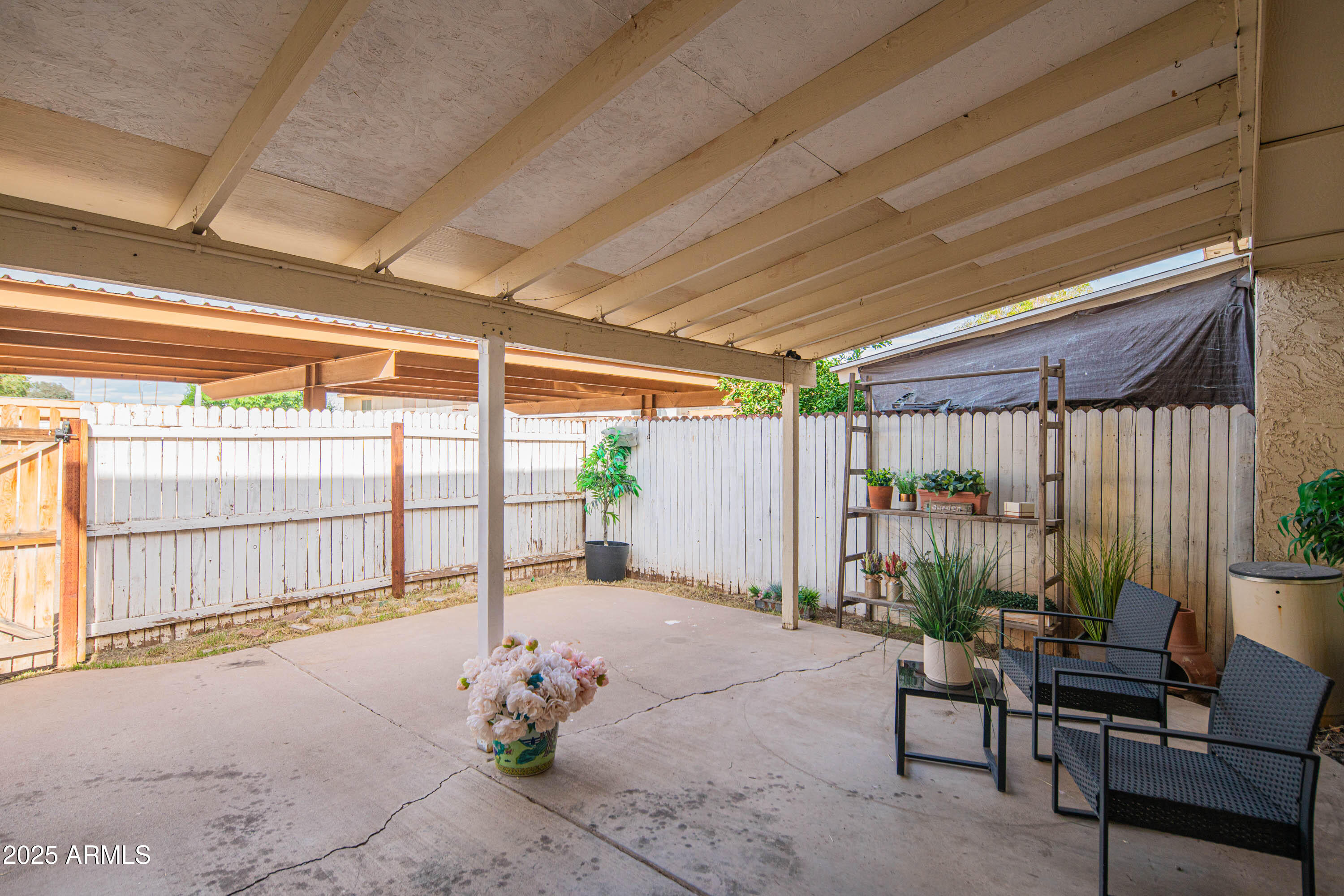 3203 West Royal Palm Road Phoenix, AZ 85051 - Photo 25 of 29 a view of a porch with furniture and a backyard