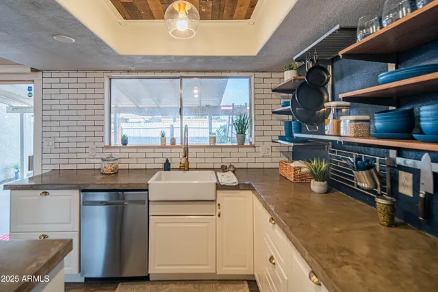 a kitchen with sink cabinets and appliances