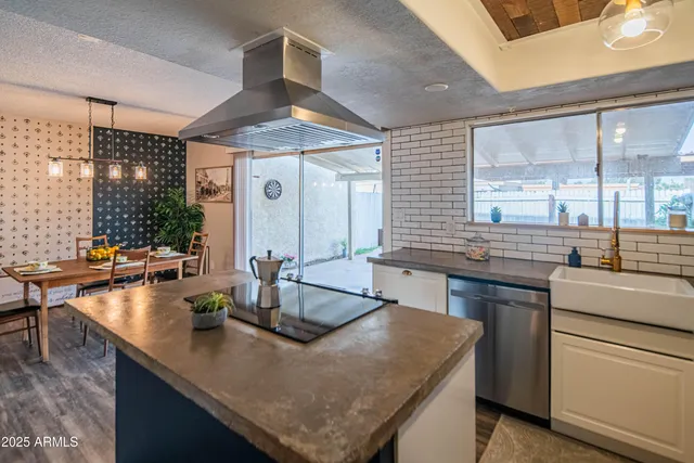 a kitchen with counter top space and living room