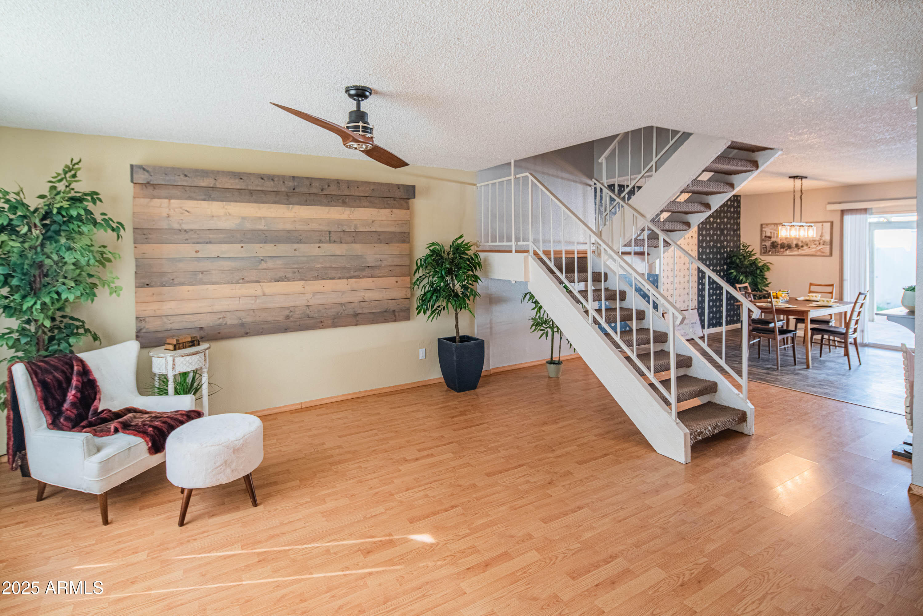 3203 West Royal Palm Road Phoenix, AZ 85051 - Photo 9 of 29 a living room with furniture and a potted plant