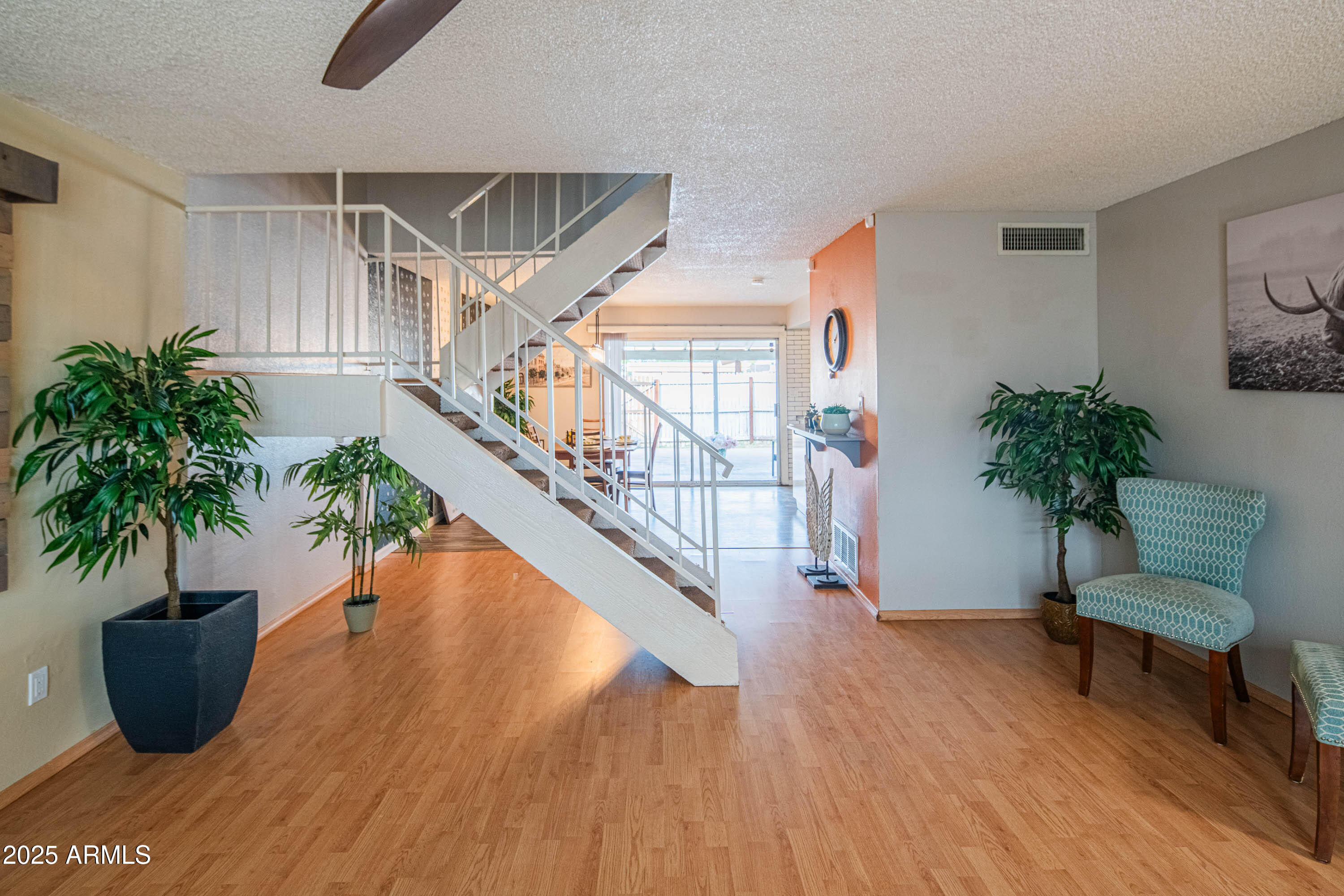 3203 West Royal Palm Road Phoenix, AZ 85051 - Photo 10 of 29 a living room with furniture potted plant and wooden floor