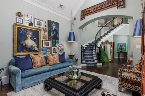 a living room with furniture and a book shelf