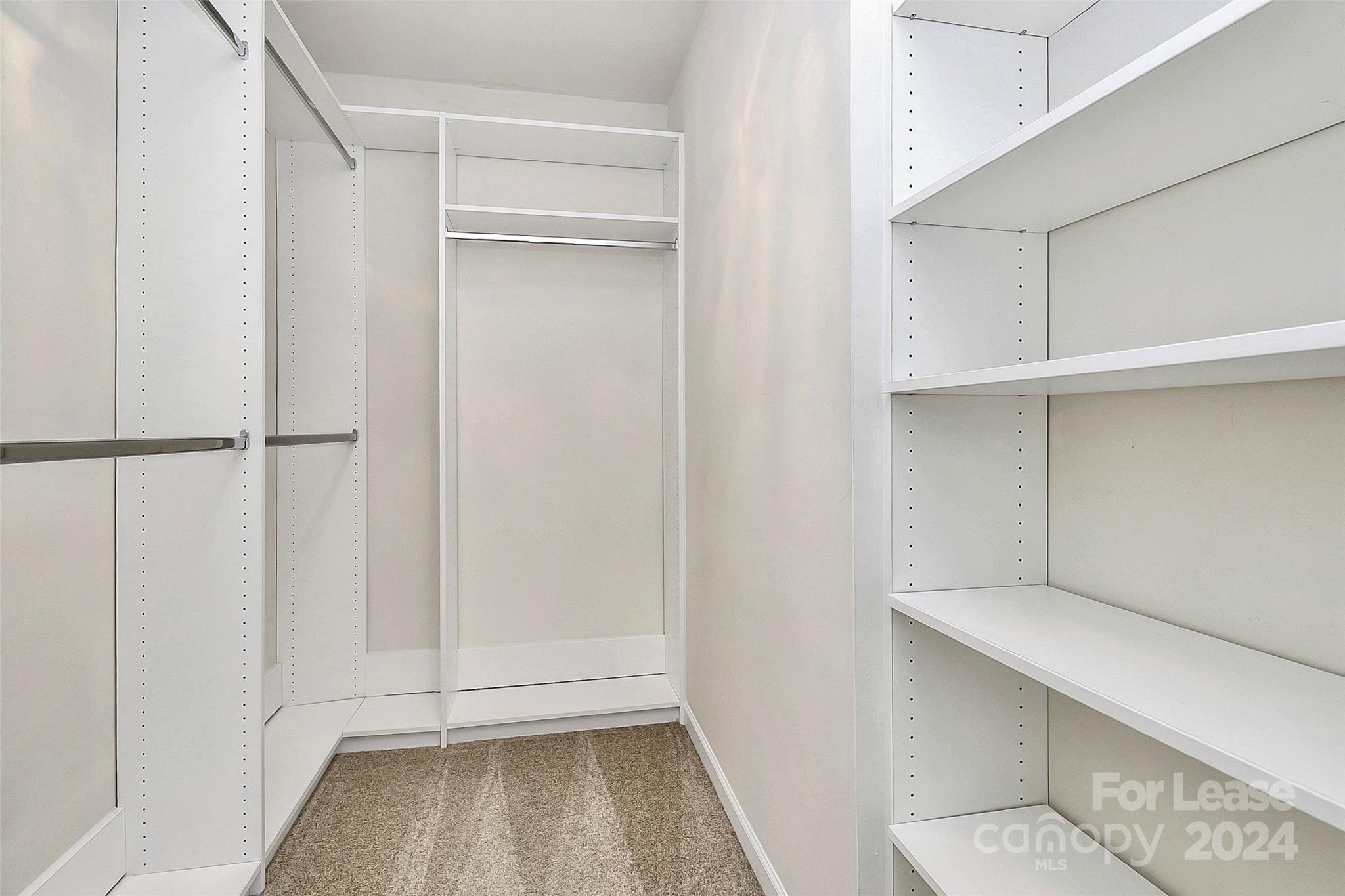 20543 Harbor View Drive Cornelius, NC 28031 - Photo 18 of 35 a view of walk in closet with empty racks