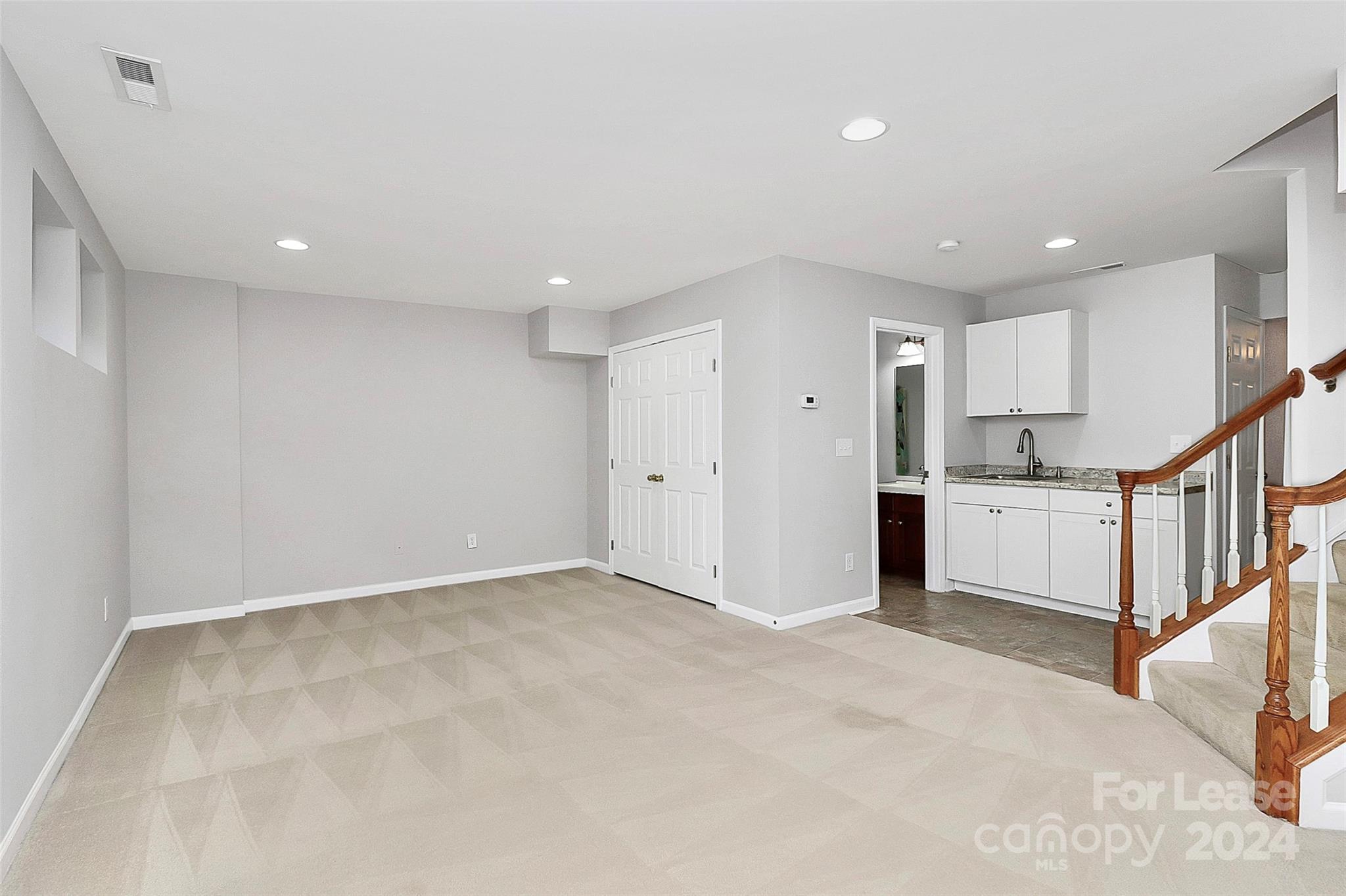 20543 Harbor View Drive Cornelius, NC 28031 - Photo 19 of 35 a view of an empty room with wooden floor and stairs