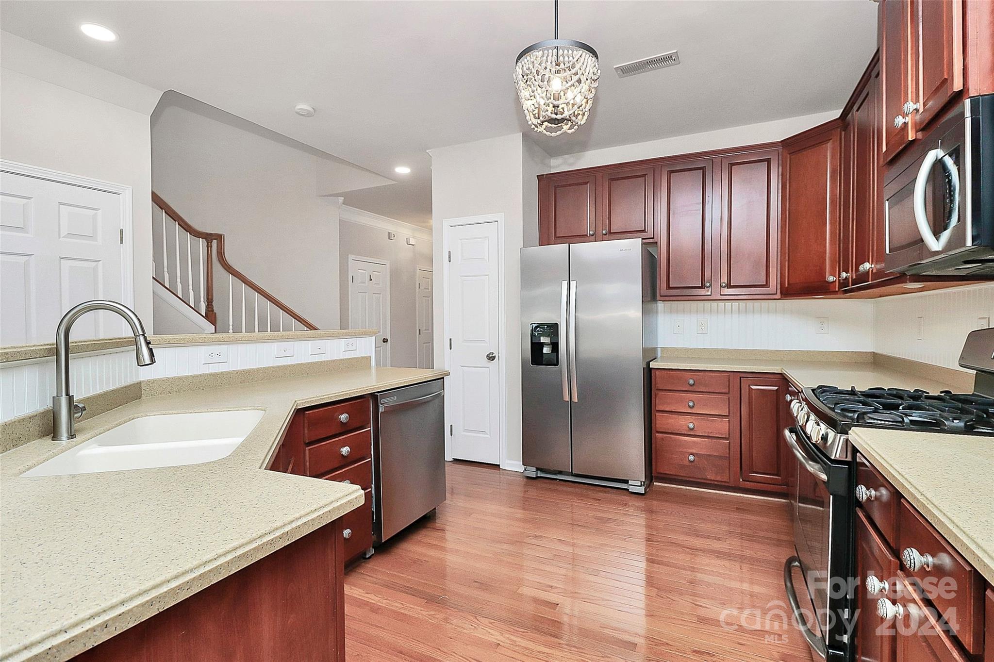 20543 Harbor View Drive Cornelius, NC 28031 - Photo 5 of 35 a kitchen with stainless steel appliances granite countertop a refrigerator a sink dishwasher a stove and a dining table with wooden floor