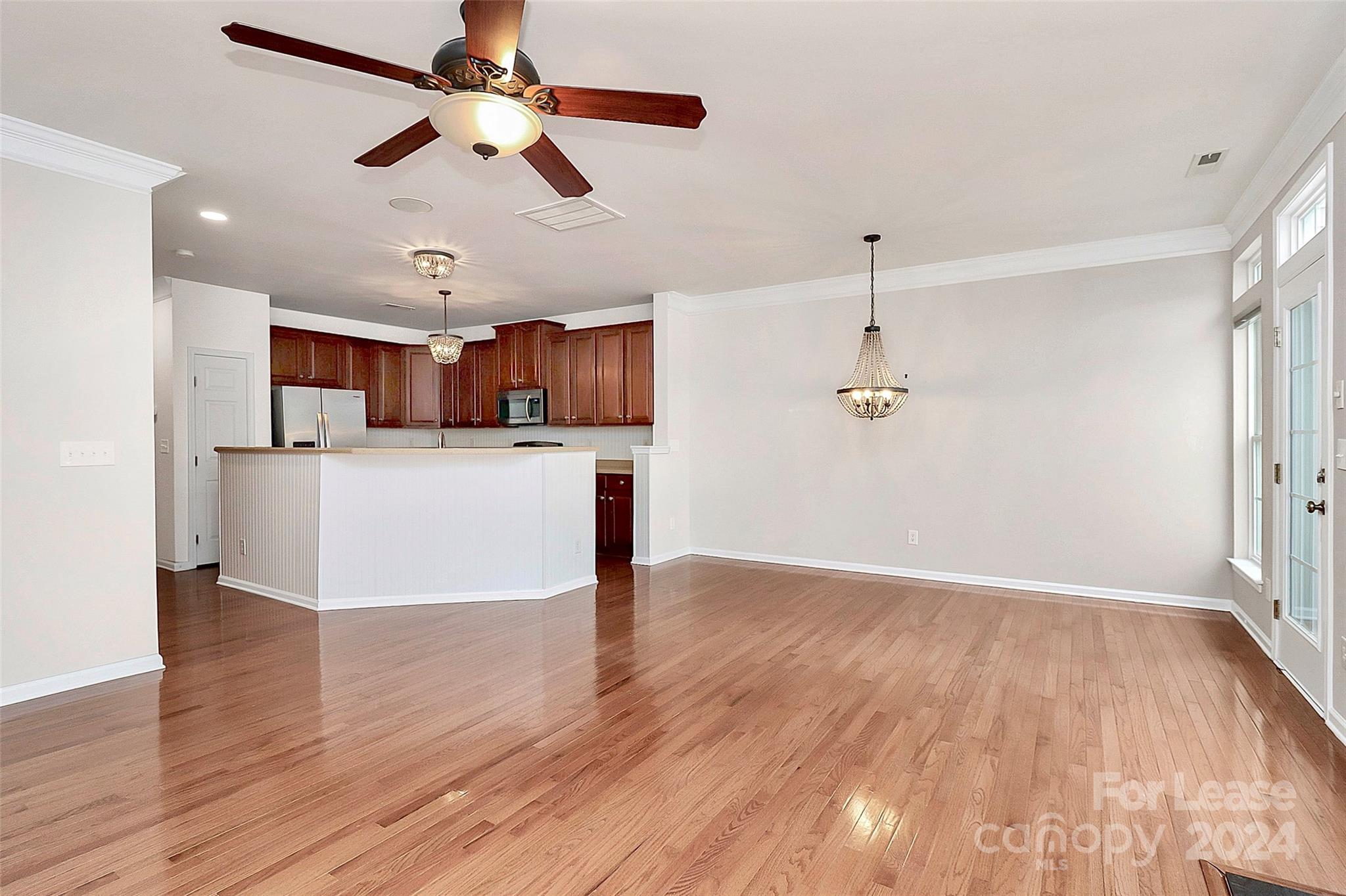 20543 Harbor View Drive Cornelius, NC 28031 - Photo 6 of 35 a view of empty room with wooden floor and ceiling fan