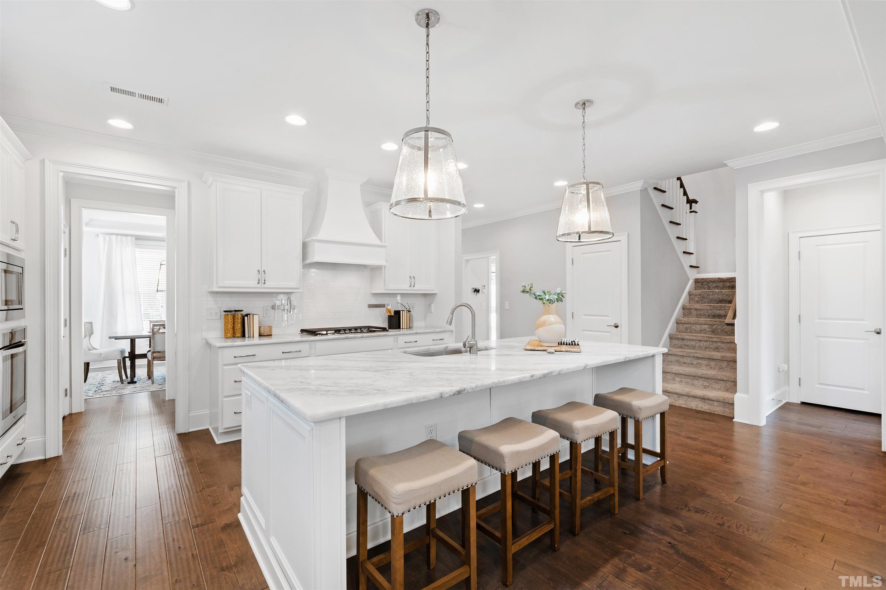 4121 Olde Judd Drive Willow Spring, NC 27592 - Photo 15 of 61 a large kitchen with kitchen island a dining table chairs and wooden floor