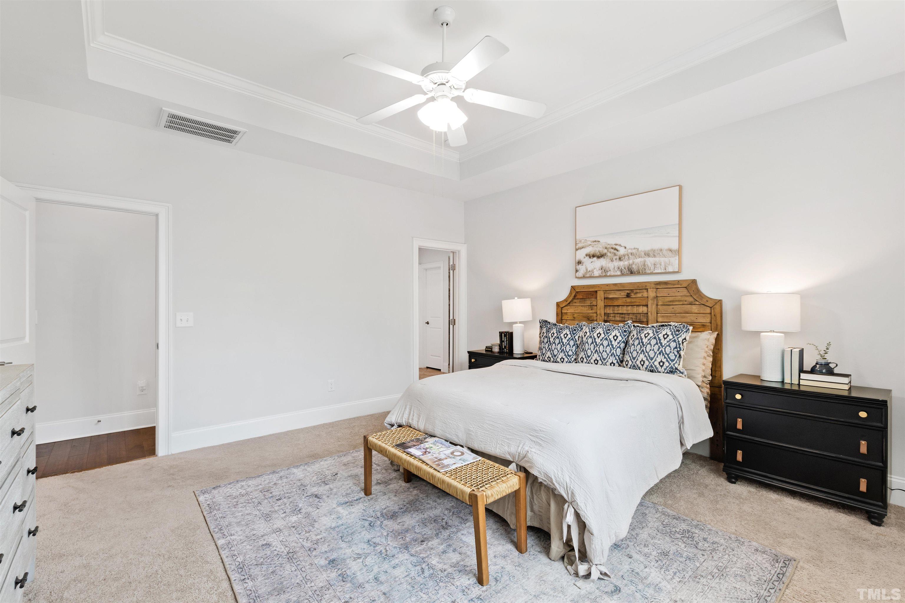 4121 Olde Judd Drive Willow Spring, NC 27592 - Photo 26 of 61 a bedroom with a bed and a chandelier