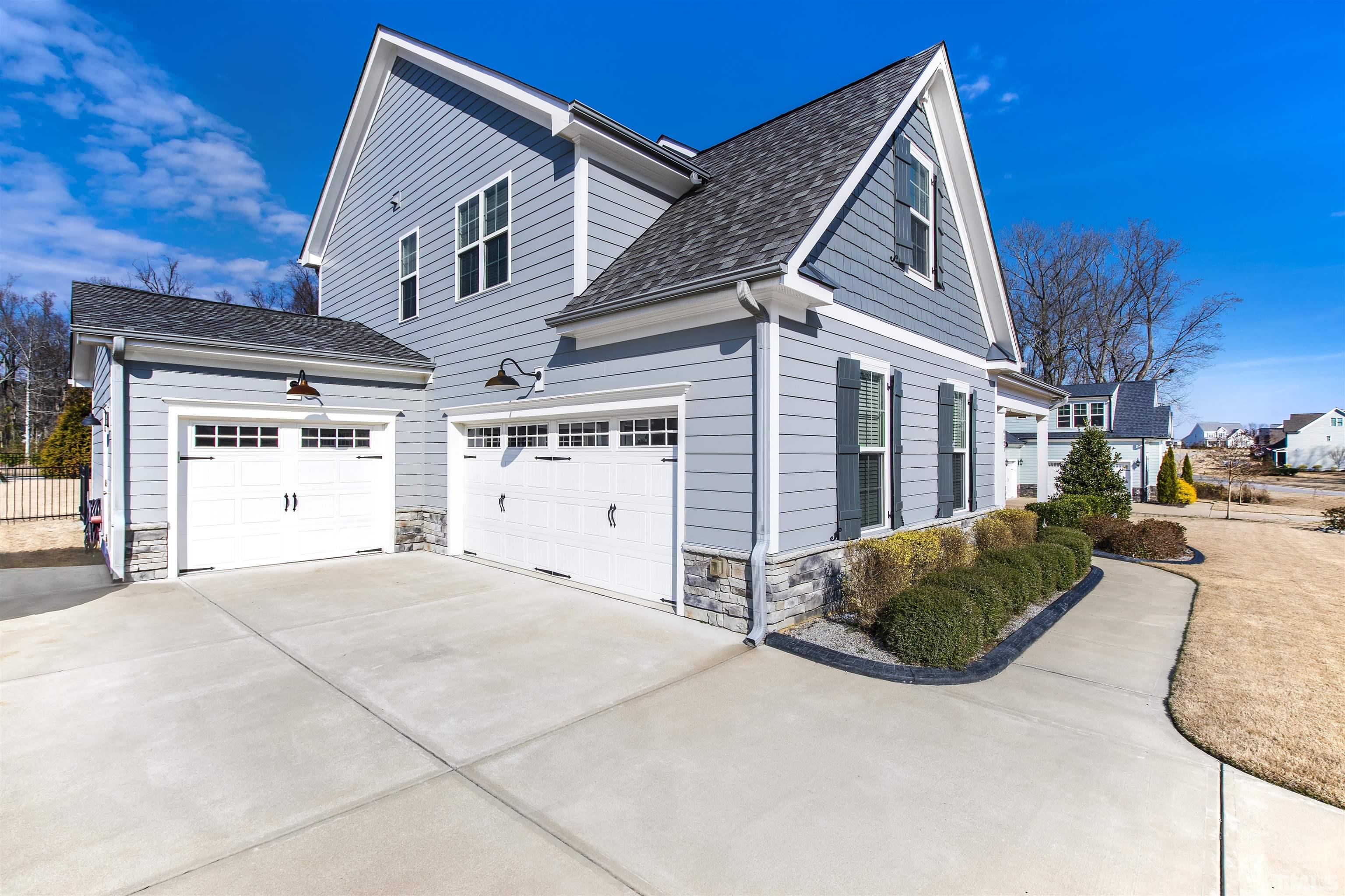 4121 Olde Judd Drive Willow Spring, NC 27592 - Photo 59 of 61 a view of a house with a yard and garage