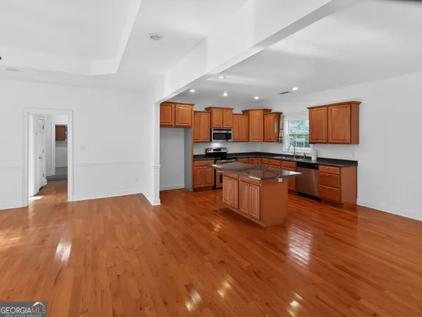 a kitchen with stainless steel appliances granite countertop a stove and a sink