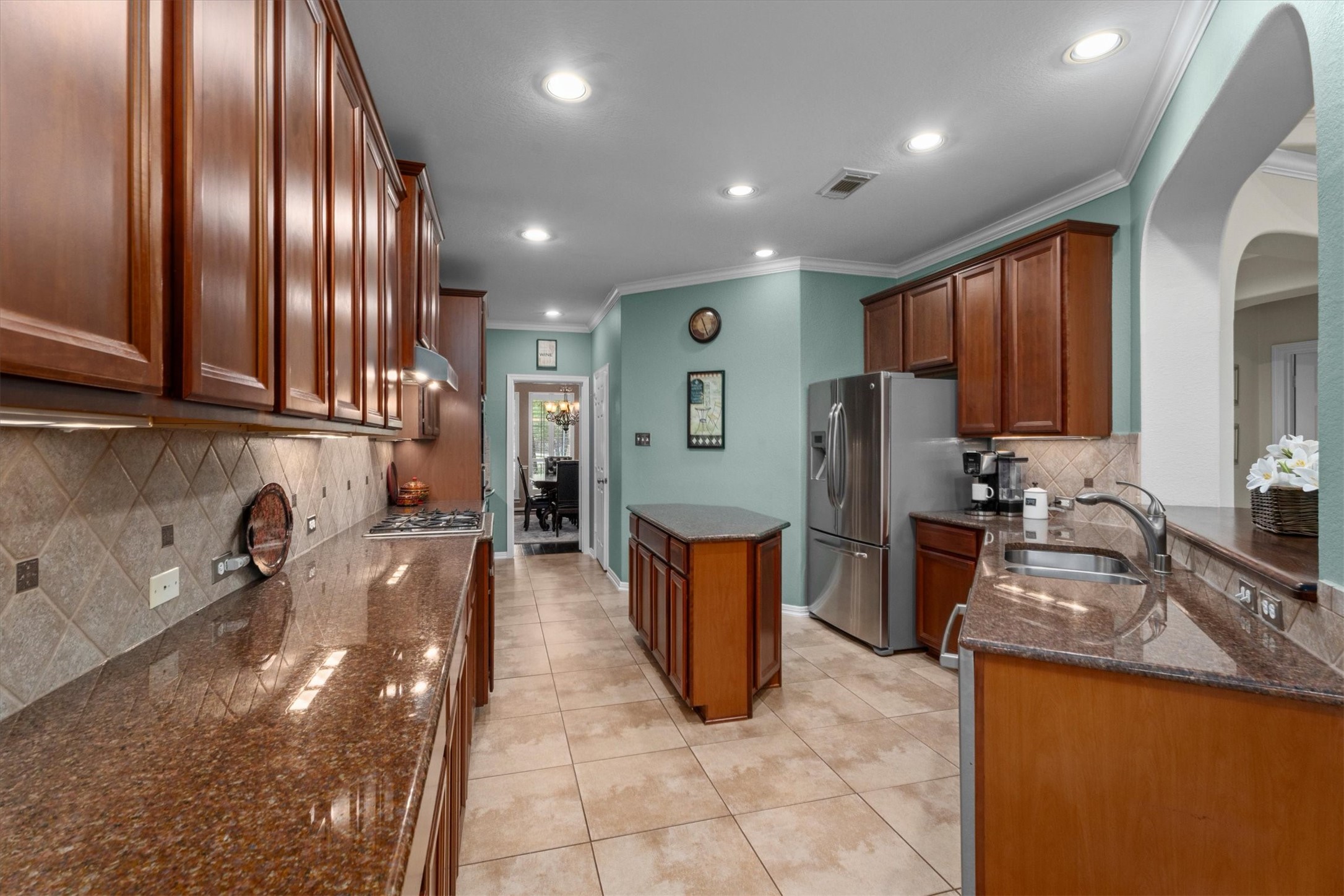 9822 Prairie Clover Lane Spring, TX 77379 - Photo 16 of 46 a kitchen with refrigerator and sink