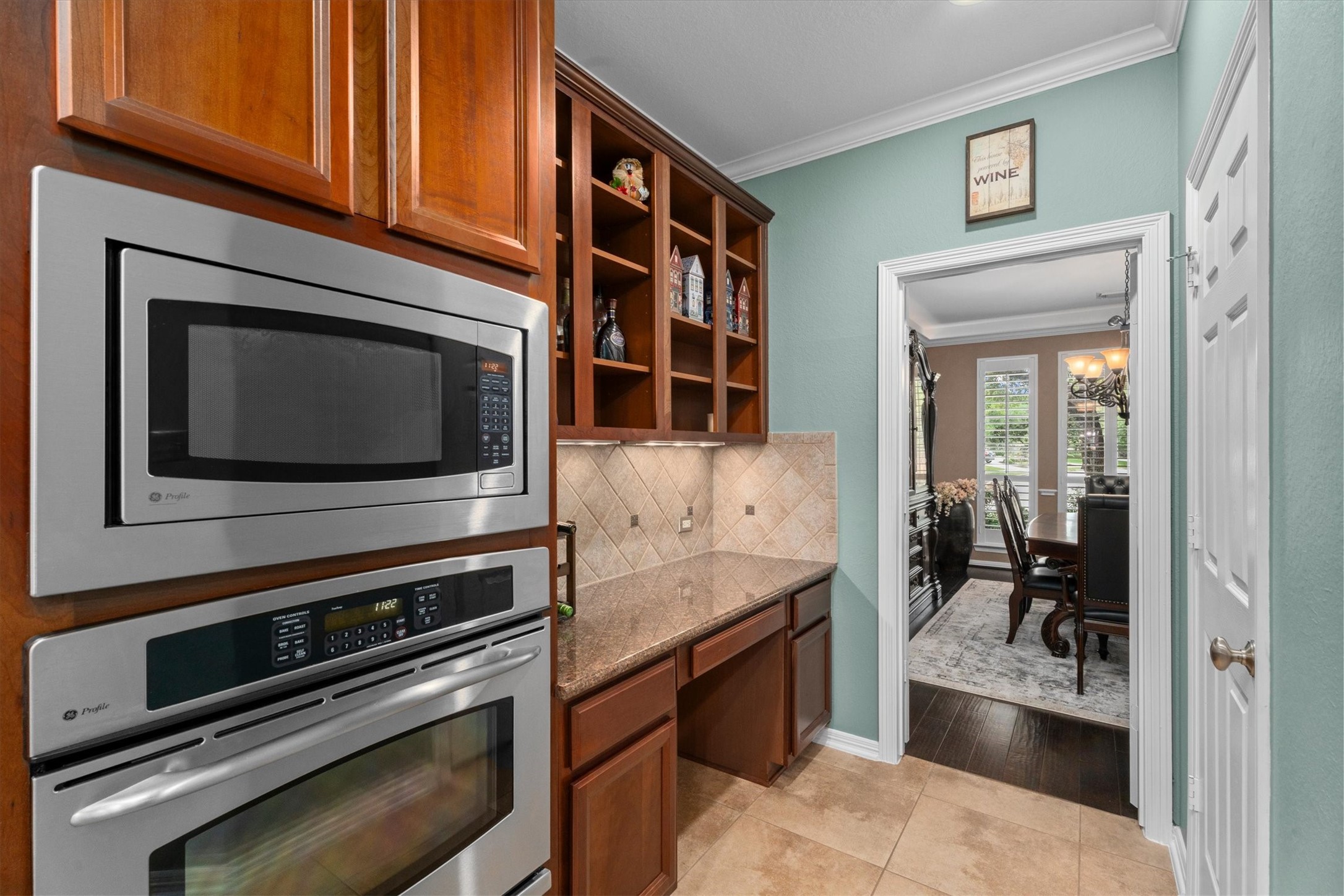 9822 Prairie Clover Lane Spring, TX 77379 - Photo 17 of 46 a kitchen with granite countertop a stove and a microwave