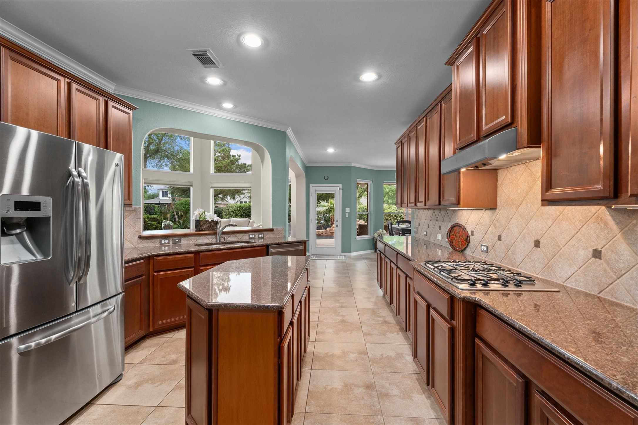 9822 Prairie Clover Lane Spring, TX 77379 - Photo 18 of 46 a kitchen with stainless steel appliances granite countertop a refrigerator a stove and a sink