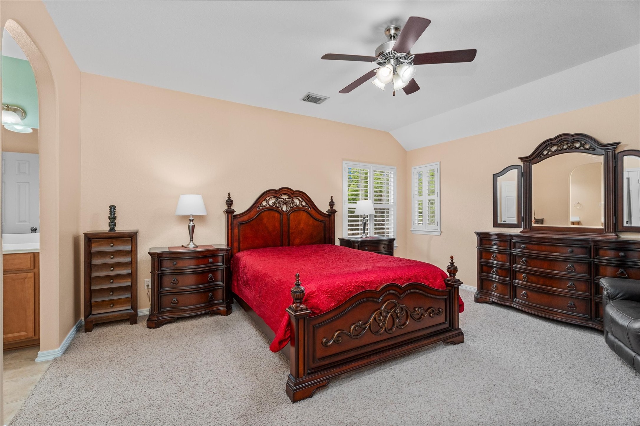 9822 Prairie Clover Lane Spring, TX 77379 - Photo 29 of 46 a bedroom with a bed and a chandelier