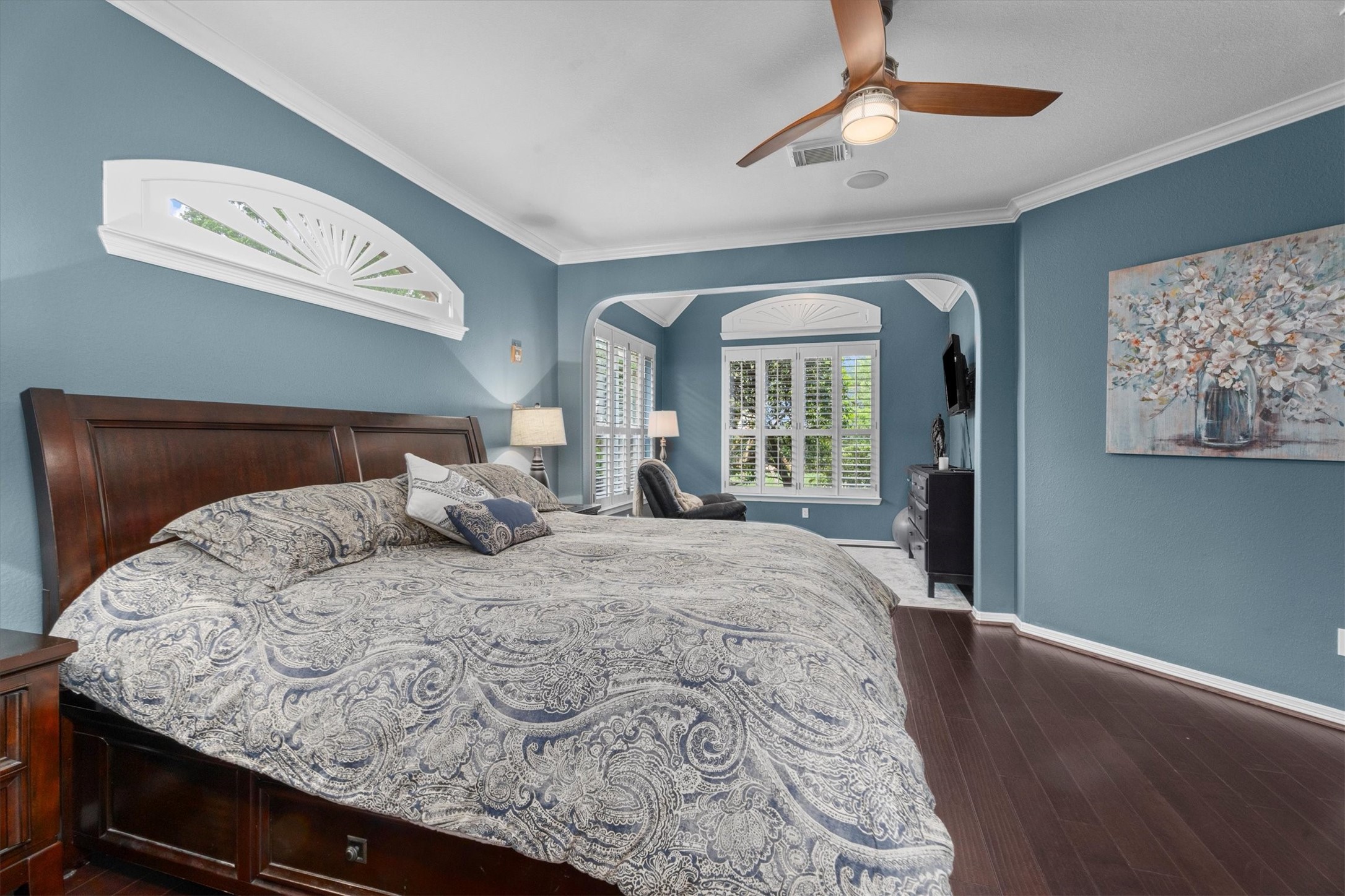 9822 Prairie Clover Lane Spring, TX 77379 - Photo 7 of 46 a bedroom with a large bed and a chandelier