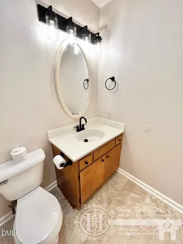 a bathroom with a sink mirror vanity and toilet