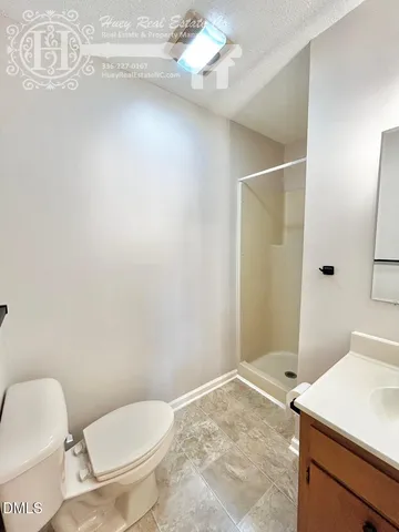 a bathroom with a toilet a sink and a shower