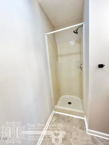 a bathroom with a glass shower door