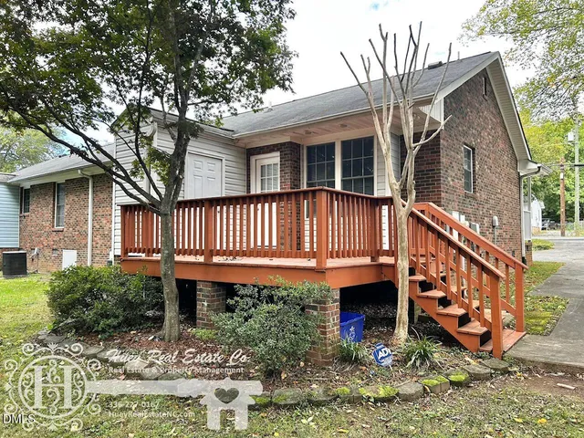 a view of a house with backyard and sitting area