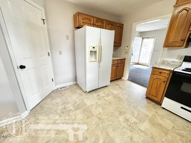 a view of a kitchen with refrigerator a washer and dryer