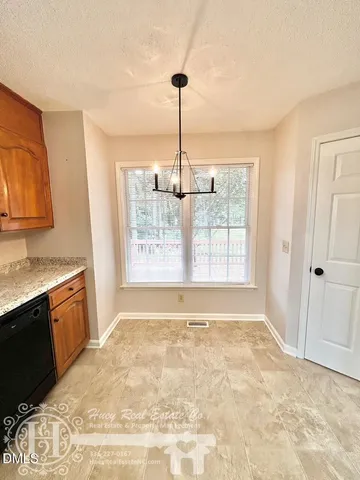 a view of an empty room with window and cabinet