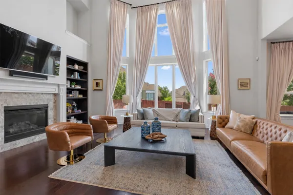 a living room with furniture fireplace and a flat screen tv