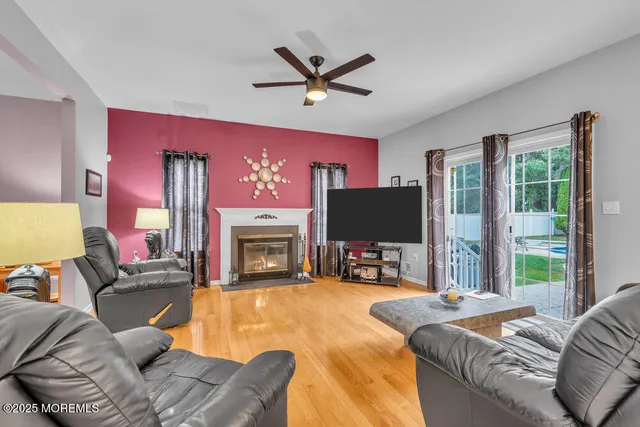 a living room with fireplace furniture and a flat screen tv