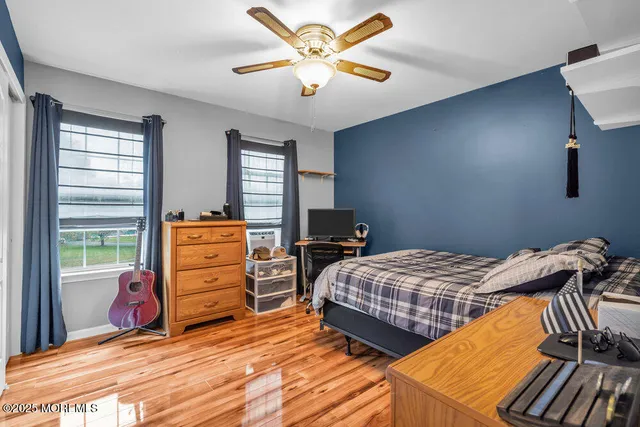 a bedroom with two beds and a chandelier