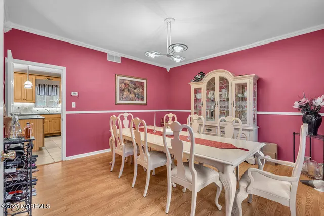 a view of a dining room with furniture and chandelier