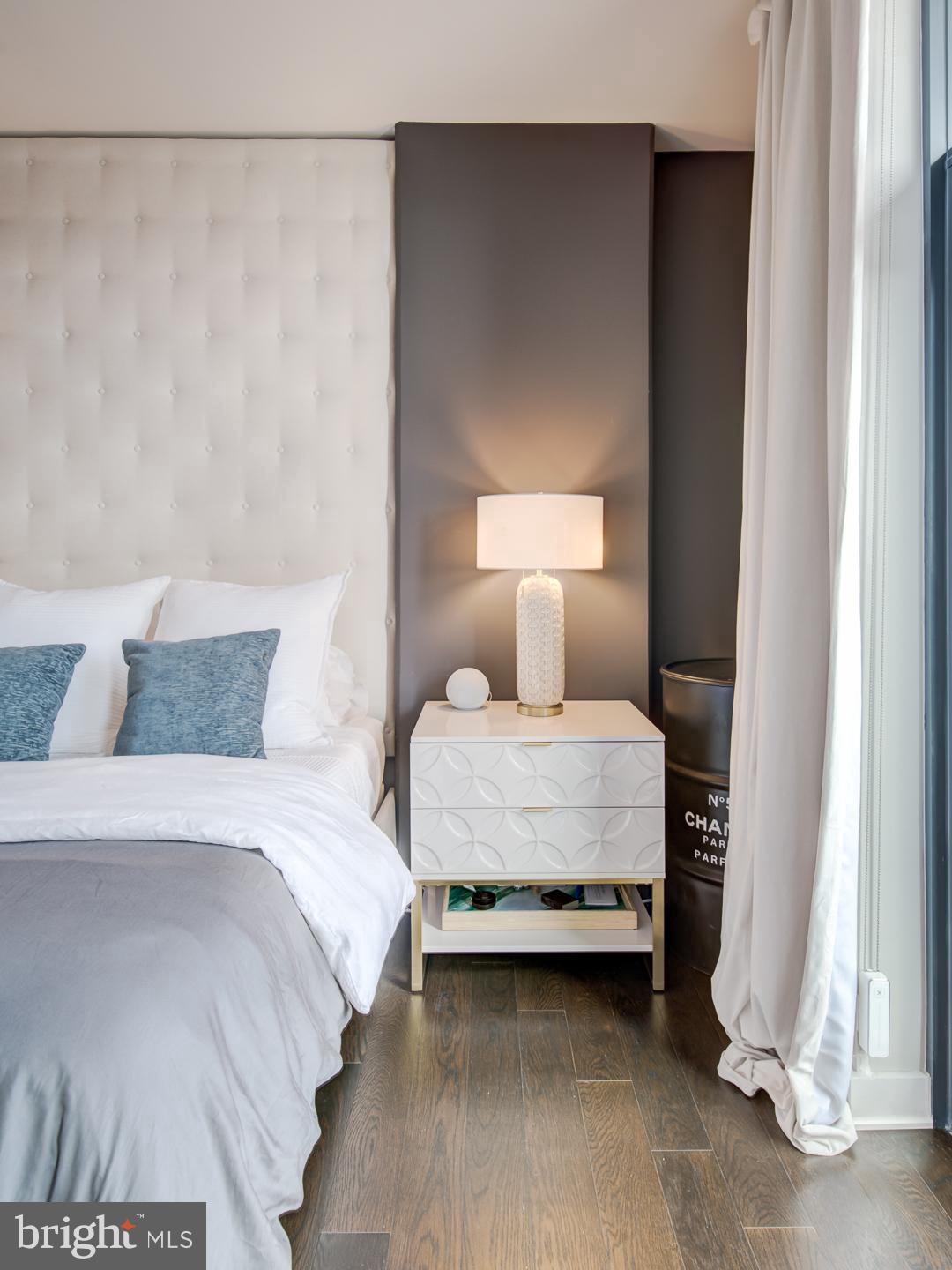 70 N Street Southeast, Unit N607 Washington, DC 20003 - Photo 16 of 21 a bedroom with a bed and a night stand