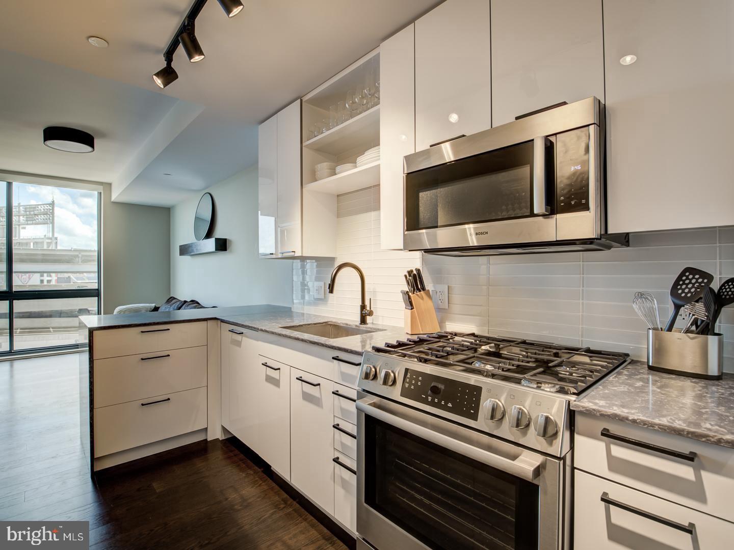 70 N Street Southeast, Unit N607 Washington, DC 20003 - Photo 6 of 21 a kitchen with stainless steel appliances granite countertop a stove and a microwave