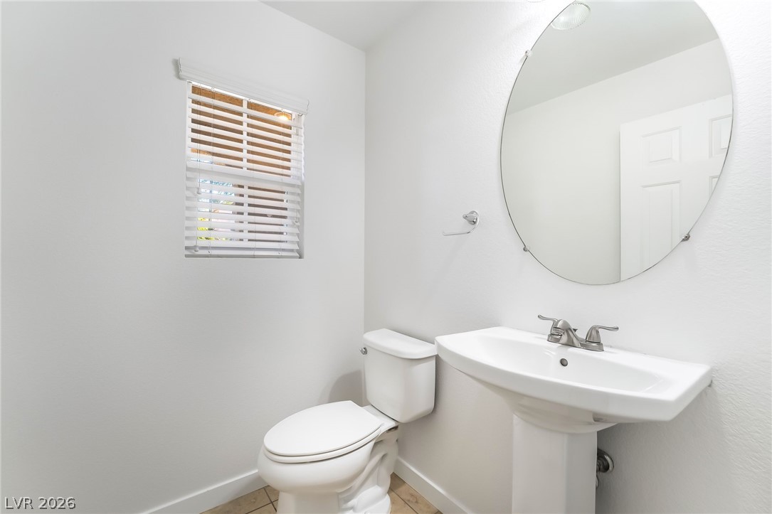 3052 Camino Rico Avenue Henderson, NV 89044 - Photo 19 of 39 Bathroom with toilet and light tile patterned floors