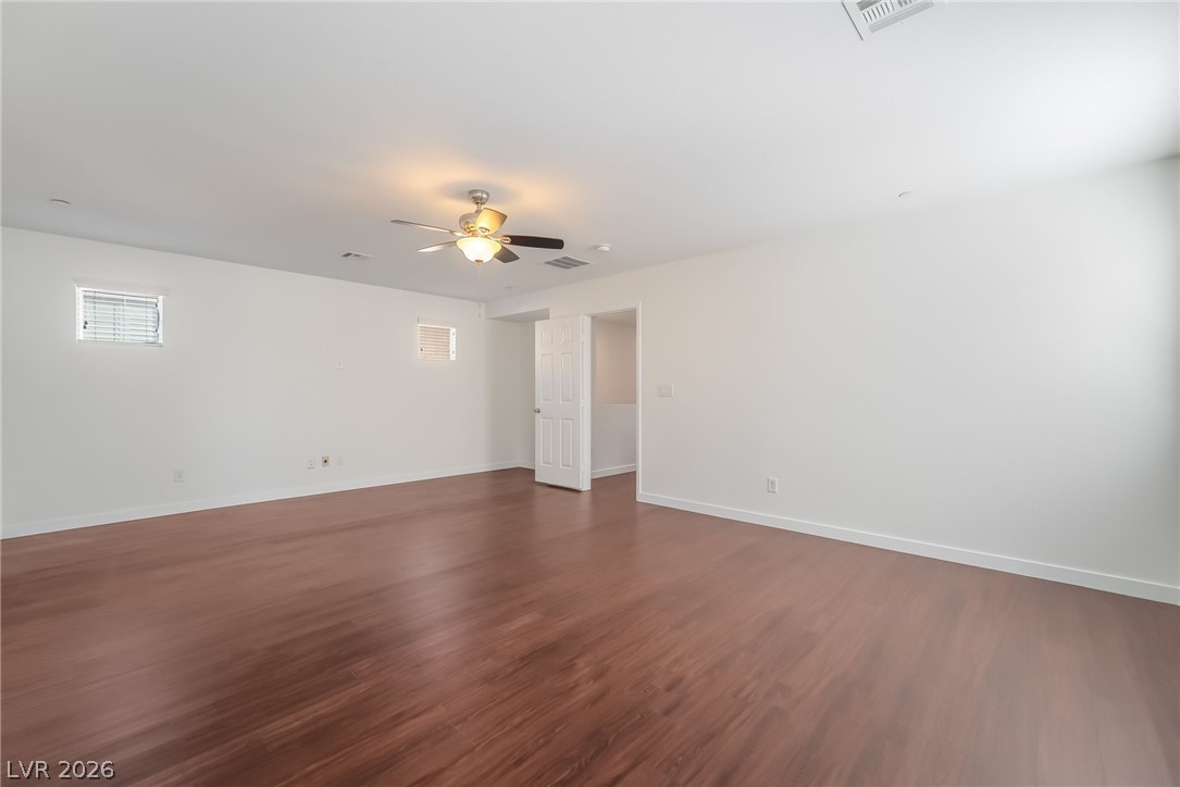 3052 Camino Rico Avenue Henderson, NV 89044 - Photo 23 of 39 Spare room featuring a ceiling fan and dark wood finished floors