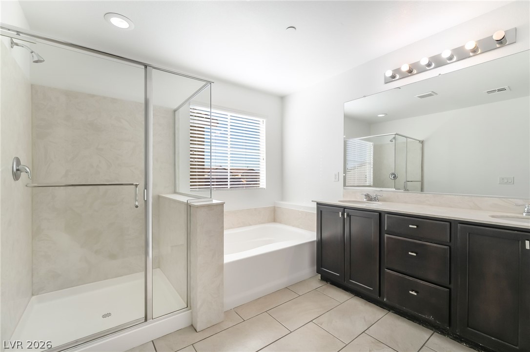 3052 Camino Rico Avenue Henderson, NV 89044 - Photo 24 of 39 Full bathroom featuring a shower stall, a bath, double vanity, light tile patterned flooring, and recessed lighting