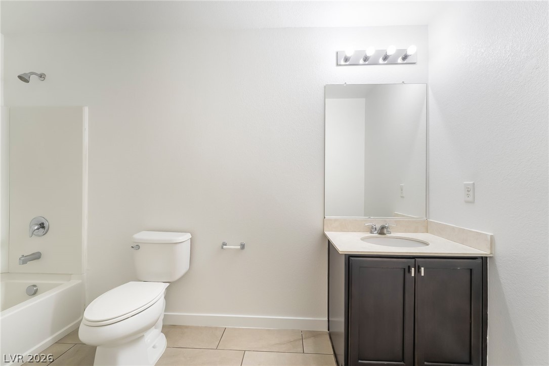 3052 Camino Rico Avenue Henderson, NV 89044 - Photo 30 of 39 Bathroom featuring vanity, bathtub / shower combination, and light tile patterned flooring