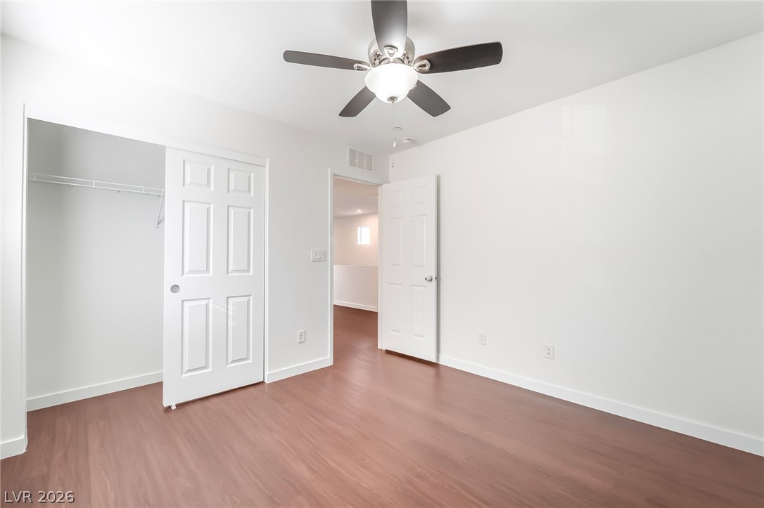 3052 Camino Rico Avenue Henderson, NV 89044 - Photo 33 of 39 Unfurnished bedroom featuring a ceiling fan, dark wood-style flooring, and a closet